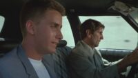 Emilio Estevez and Harry Dean Stanton drive around a city in Repo Man