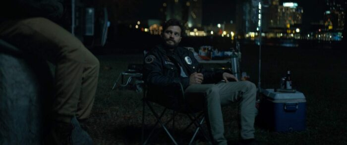 Jamie Dornan in Synchronic. He's talking to Anthony Mackie's character Steve while drinking a beer.