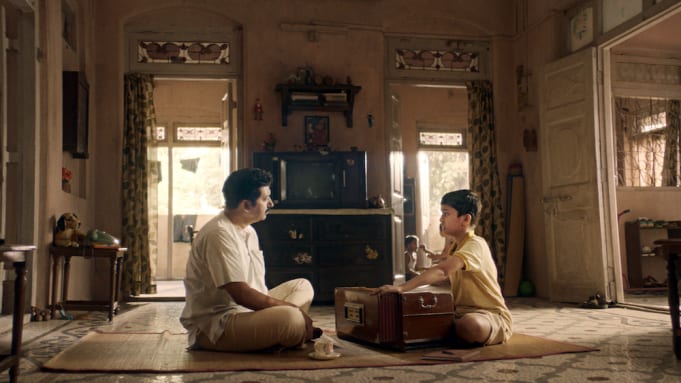 A father teaches his son to sing Alwar in The Disciple
