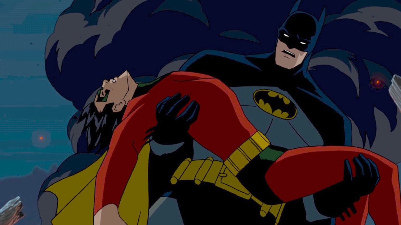 Batman holds a deceased Robin