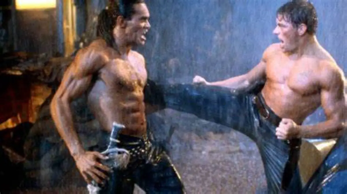 Jean Claude Van Damme launches a kick at the muscular villain in the straight to video Cyborg