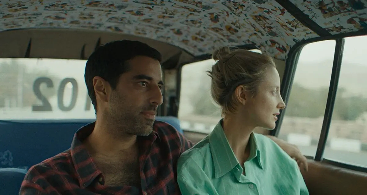 Sultan has his arm around Hana as they share a taxi.