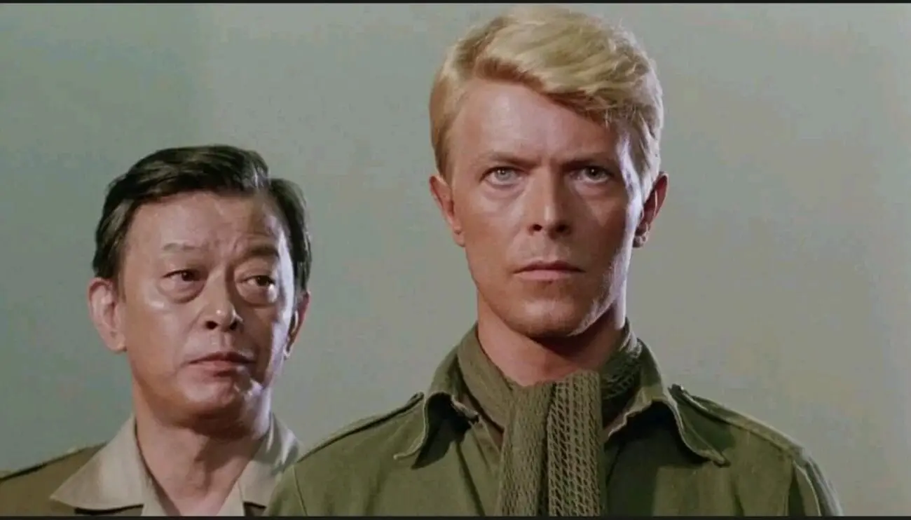 A medium show of Major Celliers (David Bowie) as a Japanese military legal defense stands beside him