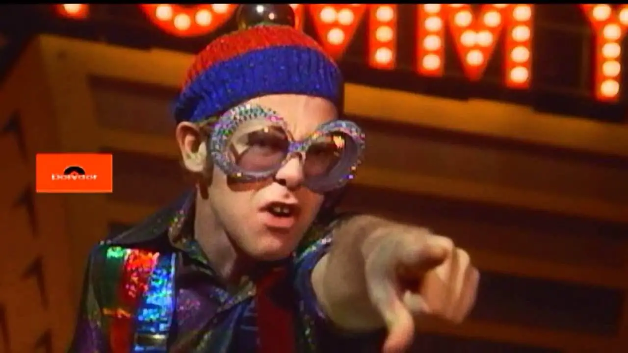 Elton John as the Pinball Champ, pointing at Tommy