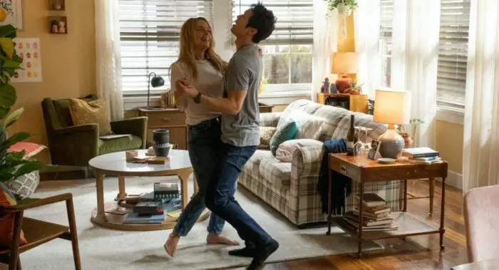 Jennifer and Sol embrace and dance in their living room