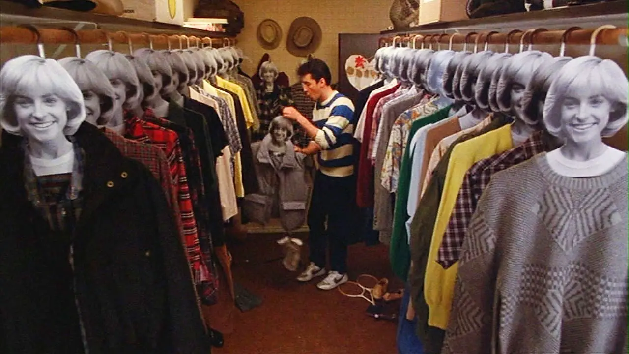 Lane stands in a large closet with images of his girlfriend Beth's face on top of clothes