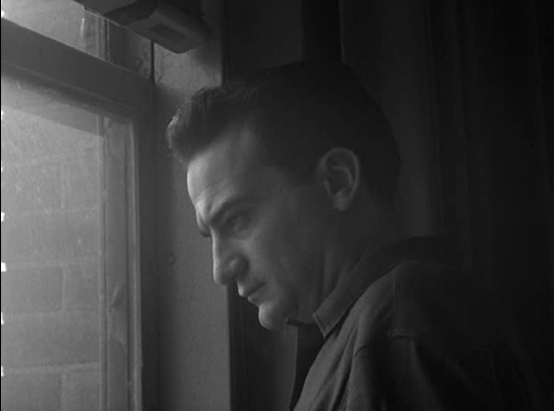 Still from Blast of Silence. Frankie Bono stares pensively out the window.