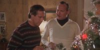 Clark and Eddie standing near the Christmas tree and talking in Christmas Vacation