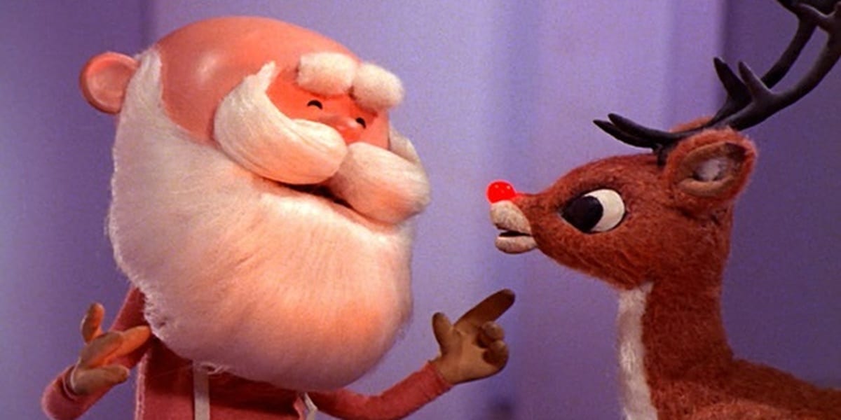 Rudolph with Santa, Santa smiling and motioning to Rudolph in Rudolph the Red Nosed Reindeer