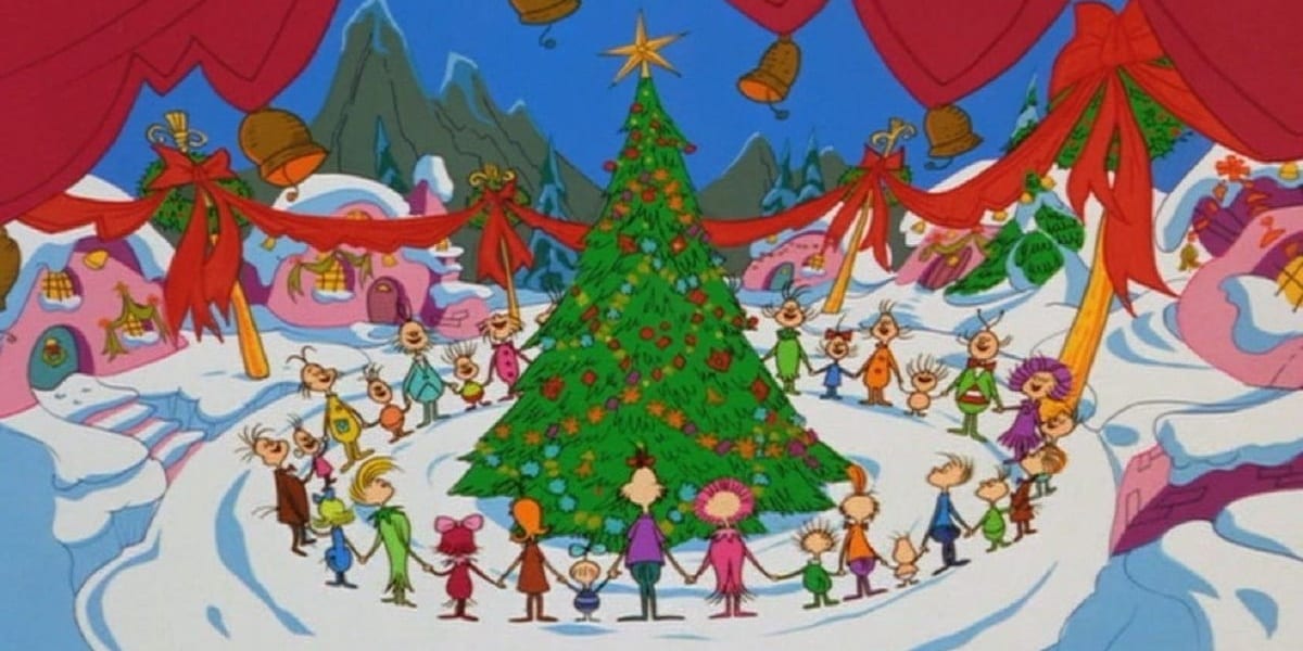 The Whos surrounding the Christmas tree in Whoville, holding hands in How the Grinch Stole Christmas