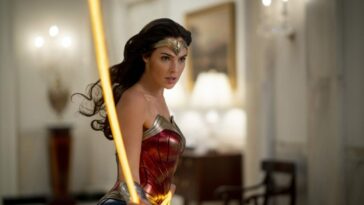 Wonder Woman twirls her lasso down a White House hallway.