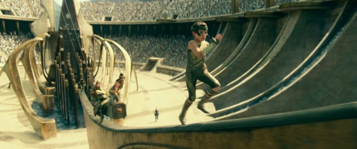 A young Diana scales a ramp in an arena.