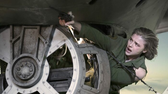 Maude angles out of a turret hatch to fire a pistol.