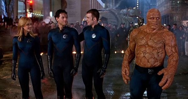 Sue Storm, Reed Richards, Johnny Storm, and Ben Grimm stand on a destroyed street
