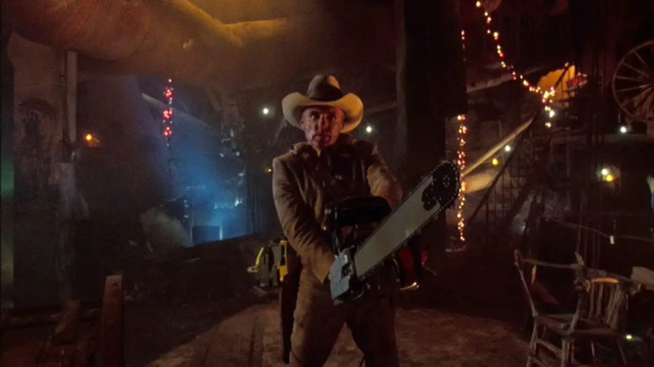 Lefty (Dennis Hopper) brandishes a chainsaw of his own as he assaults the cannibal Sawyer family's lair