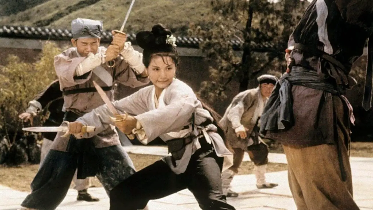 Cheng Pei-pei as Golden Swallow stands with sword drawn, fighting off assassins from all sides in the Shaw Brothers Classic, Come Dine With Me.