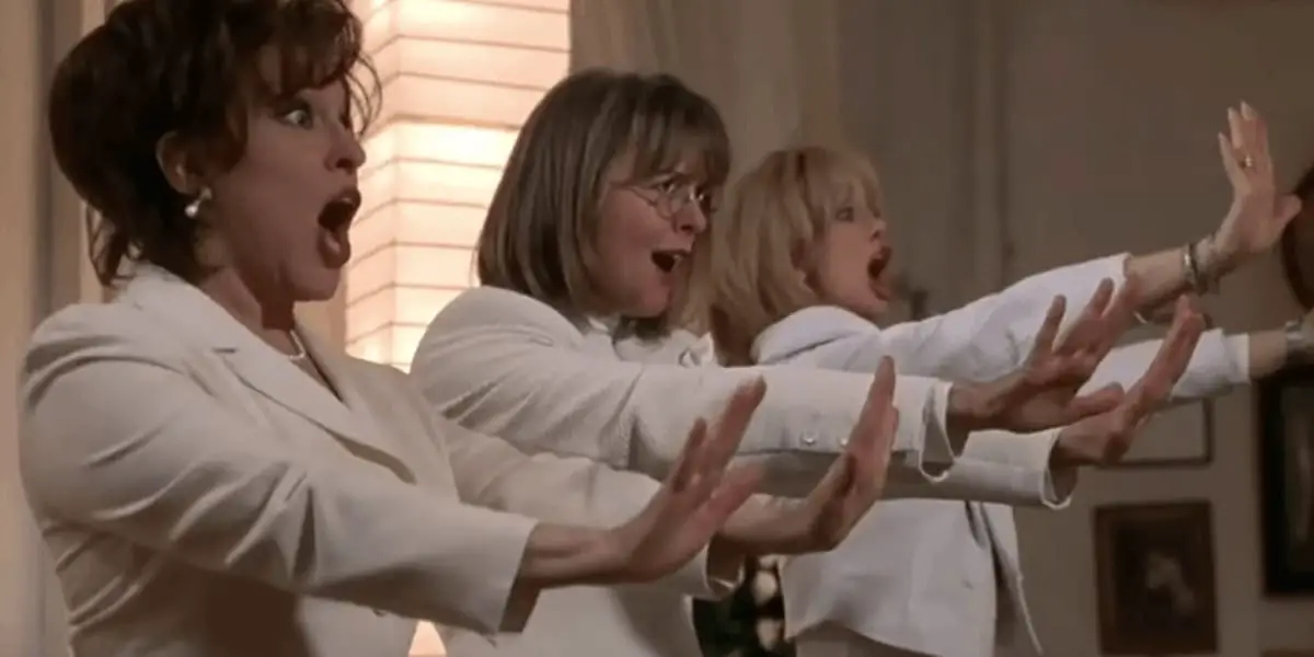 Brenda, Annie and Elise holding out their hands and singing in The First Wives Club