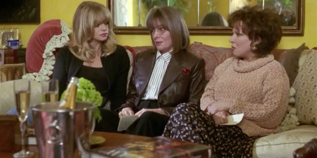 Elise, Annie and Brenda talking and sitting on a couch in The First Wives Club