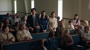 Steven Yeun, Yeri Han, and Yuh-jung Youn stand in a church surrounded by sitting people