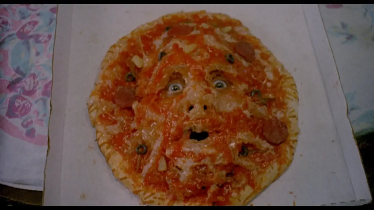 A pizza with a face in the center