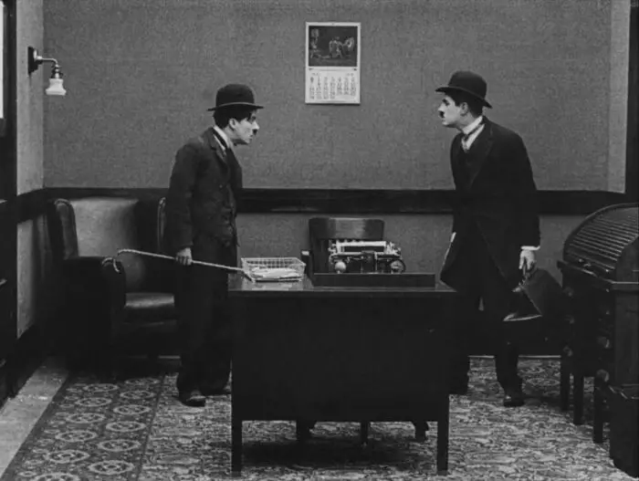 Criterion Channel Shorts March. Still from The Floorwalker. Charlie Chaplin encounters fake Charlie Chaplin in an office.