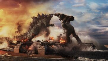 Kong swings a punch towards Godzilla while the two stand on an aircraft carrier.