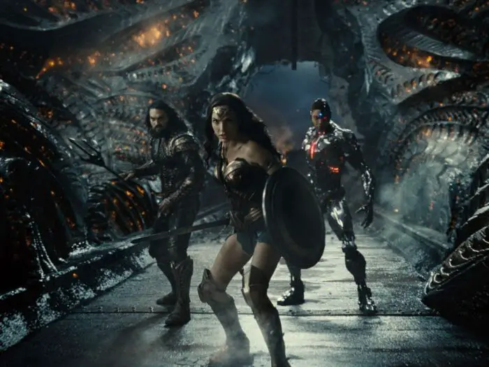 Wonder Woman, Aquaman, and Cyborg confront their opponent ready for battle.
