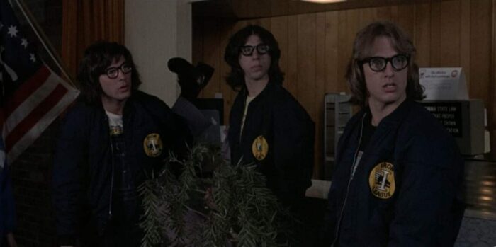 The Hanson brothers gaze across a motel lobby.