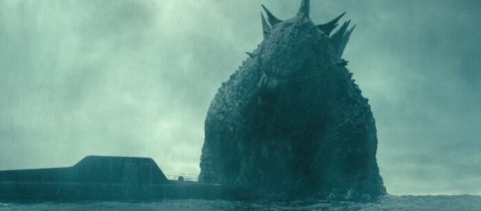 Godzilla appears next to a submarine