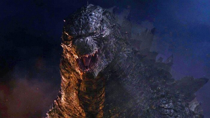 Godzilla growls and glares in the dark.