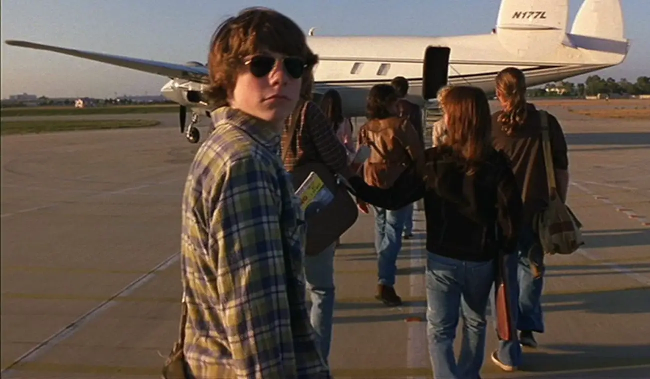 William Miller boards a plane with the band members of Stillwater 