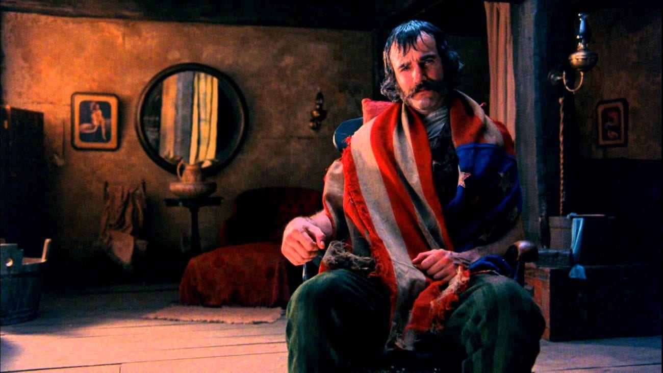 Bill sits in a chair with a flag around his neck