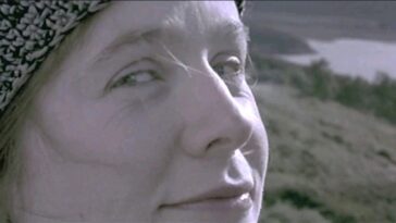 A close-up shot of Bess McNeill (Emily Watson) looking directly at the camera