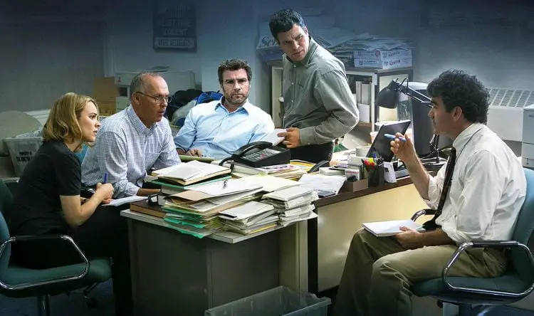 The spotlight news team of The Boston Globe sit over an office desk