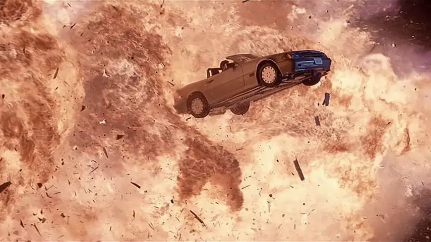 A Mercedes flying through the air surrounded by fire