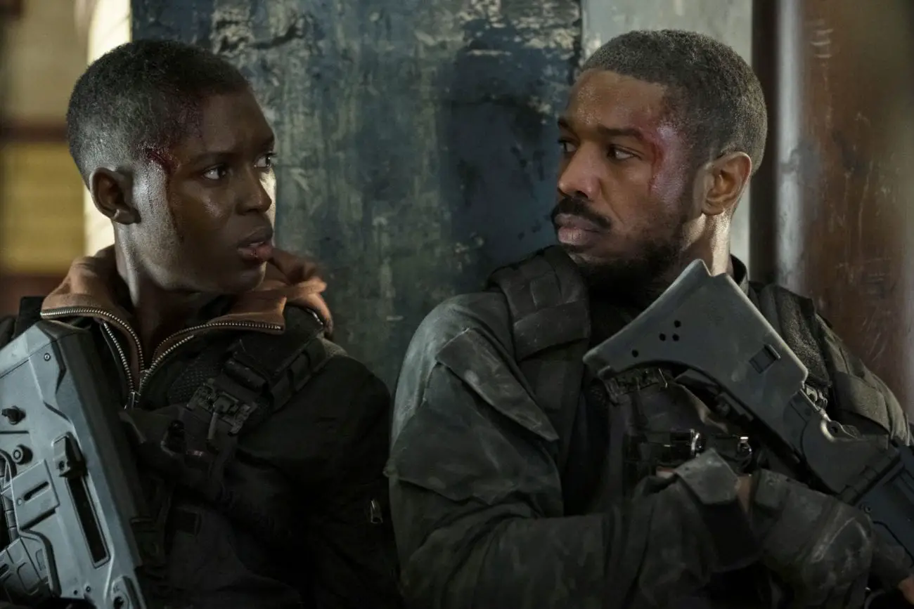 Greer and Kelly talk while pinned down in a firefight.