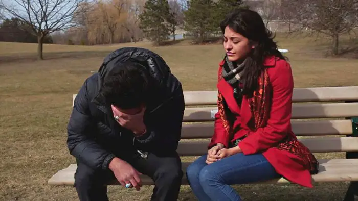 Gabriela comforts Ethan on a park bench in Toronto