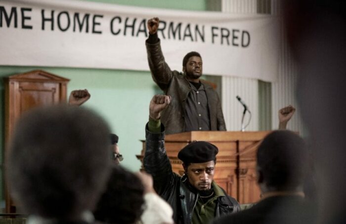 Daniel Kaluuya and LaKeith Stanfield raise their fists in a church