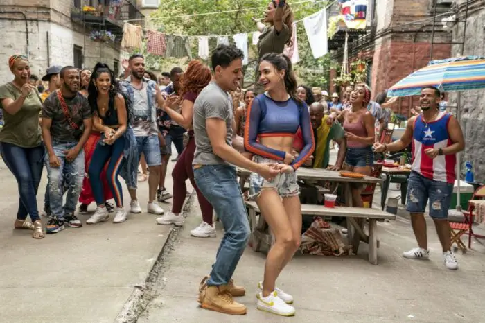 Usnavi and Vanessa dance together in front of a street crowd.