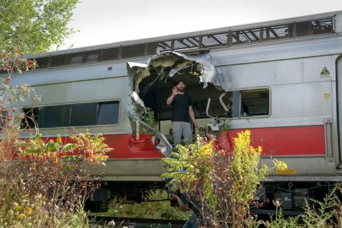 Director John Krasinski is shown on the set of a train car.
