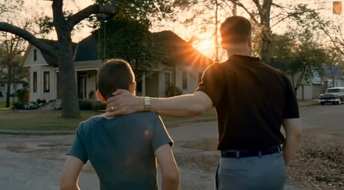 Brad Pitt leads his son down a suburban street at sundown