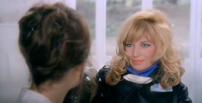 A landrette worker is captivated by the blonde in black leather
