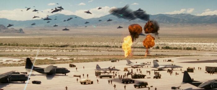 The alien attackers fire upon a military base.