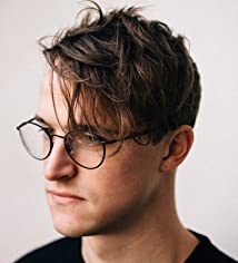 Zak Engel, composer for Ultrasound, has scruffy hair and wears glasses, clean-shaven