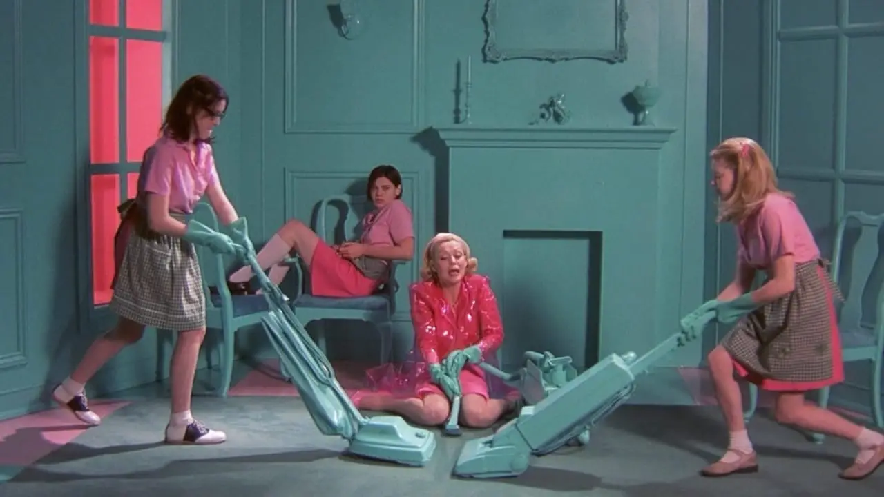 But I'm A Cheerleader (1999) Hilary (Melanie Lynskey) duels with Megan (Natasha Lyonne) while vacuuming, as Mary Brown (Cathy Moriarty) and Graham (Clea DuVall) look on.