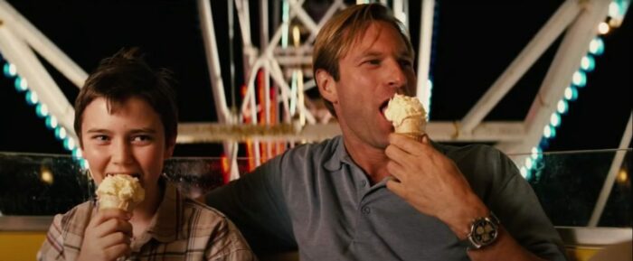 Joey (Cameron Bright) and Nick Naylor (Aaron Eckhart) happily eating vanilla ice cream on a Ferris wheel in Thank You for Smoking
