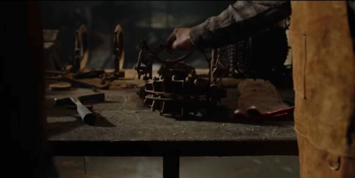 Jigsaw sets a reverse bear trap on the table.