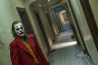 The Joker walks down a twisted hallway