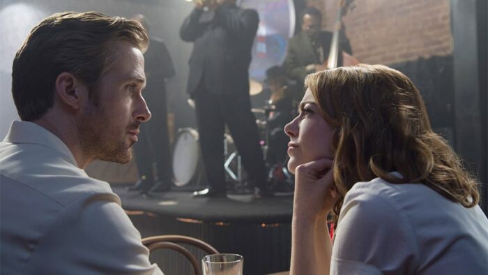 Emma Stone looks lovingly at Ryan Gosling in a jazz club