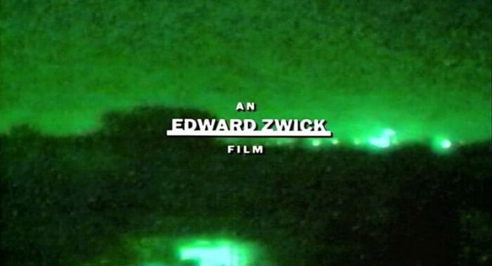 In this image from the opening credits sequence of Courage Under Fire, the text reads "An Edward Zwick film" over images of nighttime Gulf War aerial strikes.